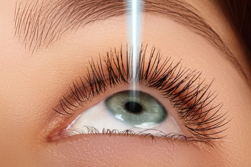 Close-up of an eye during a conceptual laser treatment of the cornea